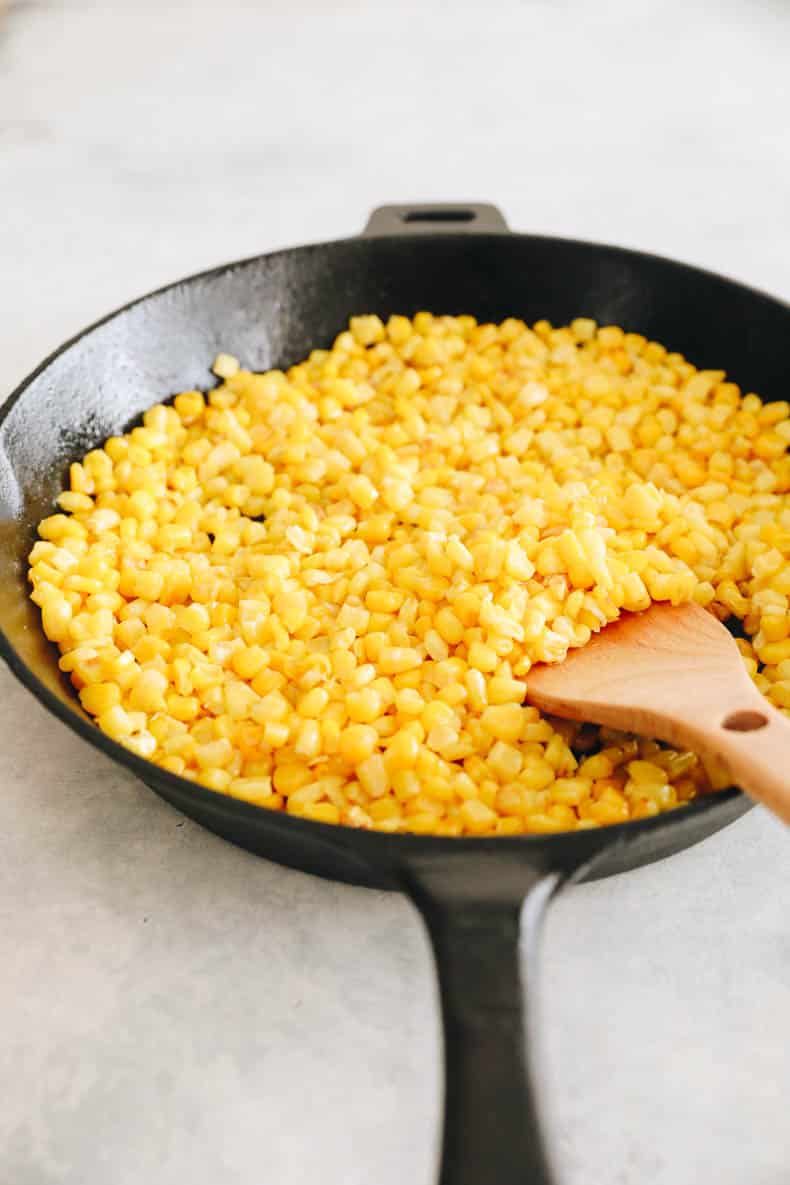 cooked corn kernels in a cast iron