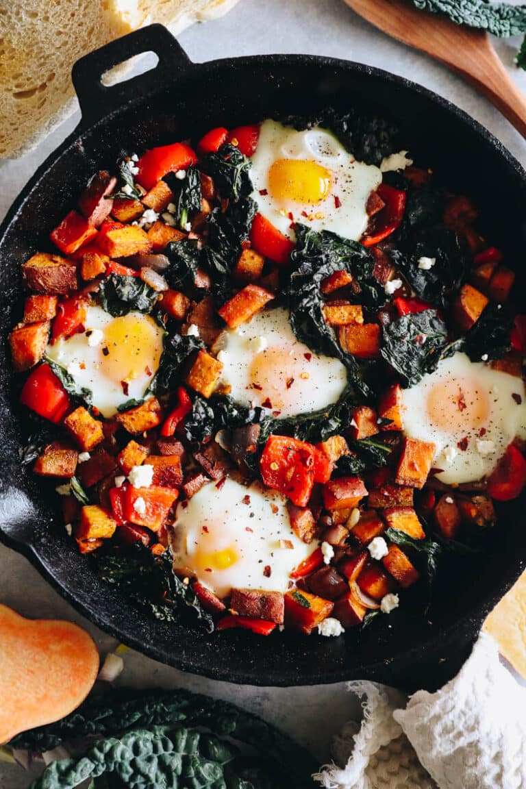 Sweet potato hash with baked eggs in a cast iron skillet