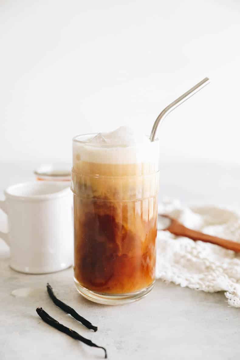cold brew coffee in a glass cup topped with vanilla sweet cream.