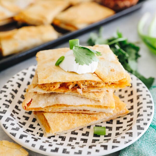 sheet pan quesadillas cut into rectangles and stacked on a plate