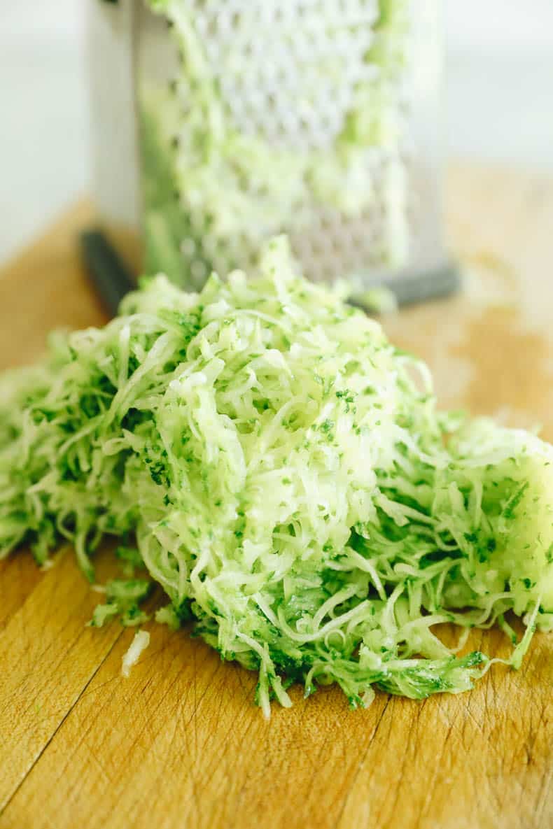 a box grater with shredded zucchini