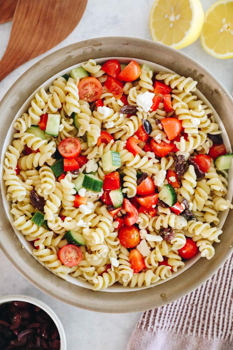 Greek pasta salad with feta, tomatoes, cucumber and bell peppers