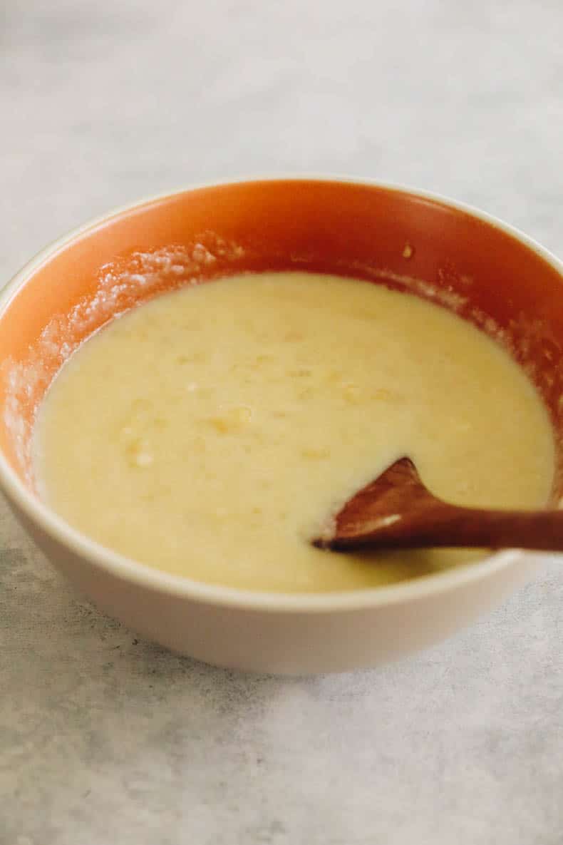 banana zucchini muffin batter in a brown bowl.