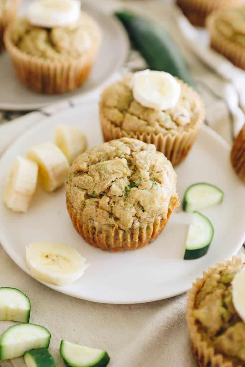 banana zucchini muffins on a white plate.