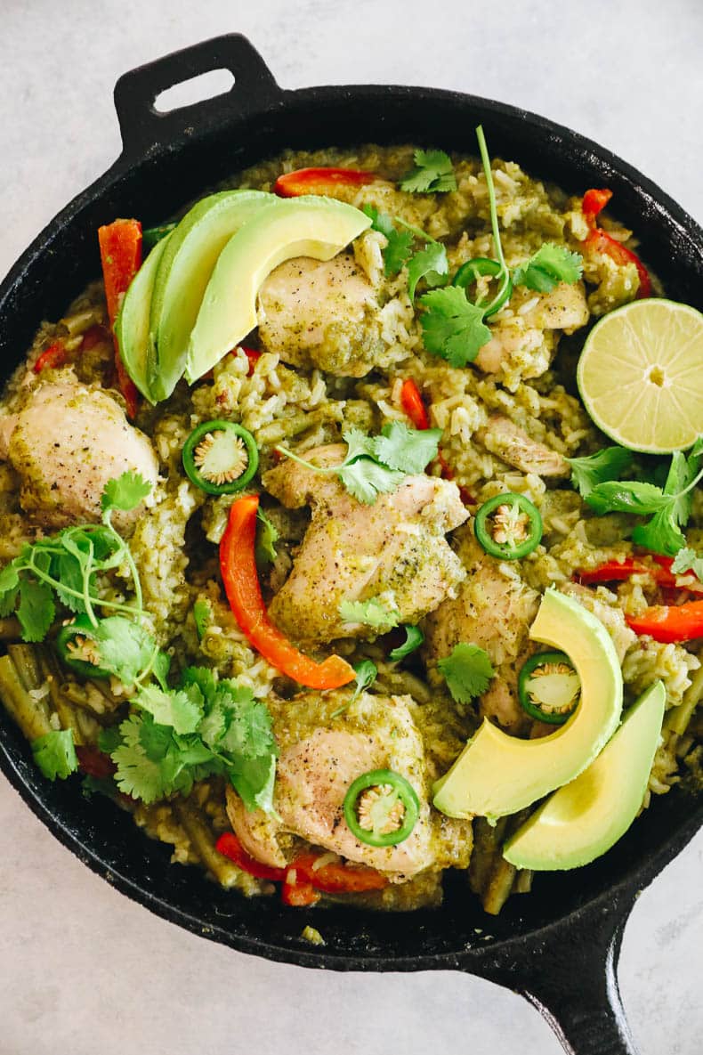 cooked cilantro lime chicken in a cast iron topped with fresh avocado, cilantro and jalapeno.