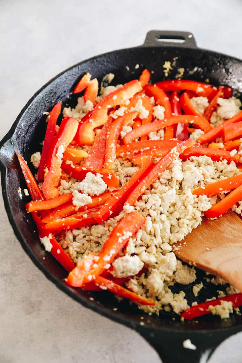 sautéed ground chicken and red bell peppers in a cast iron