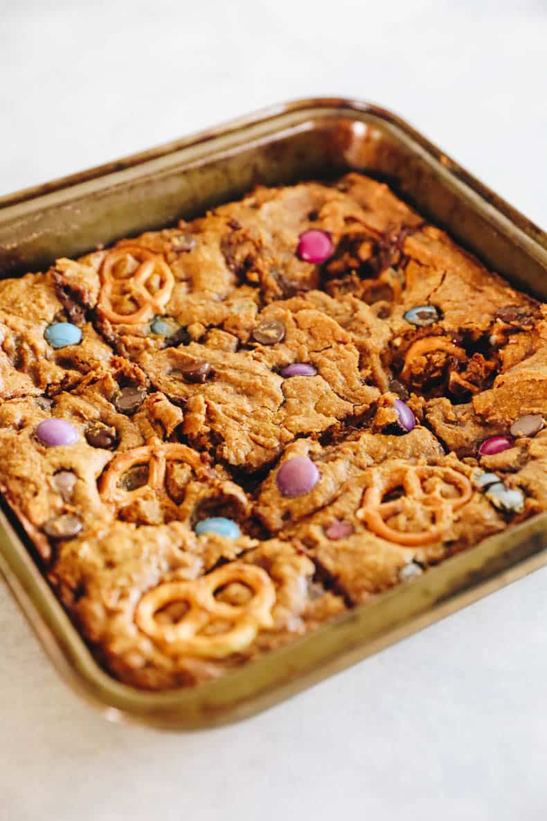 Baked pumpkin monster cookie bars in a baking pan.