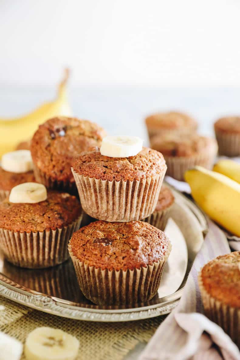 almond flour banana muffins stacked on a silver platter.