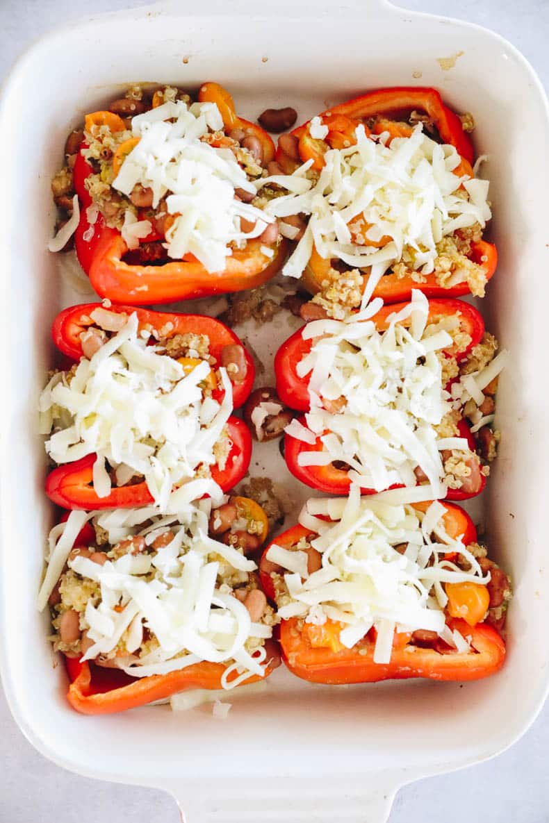 Quinoa stuffed peppers topped with cheese