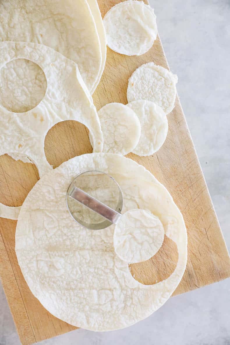 round cookie cutting cutting circles out of tortillas.