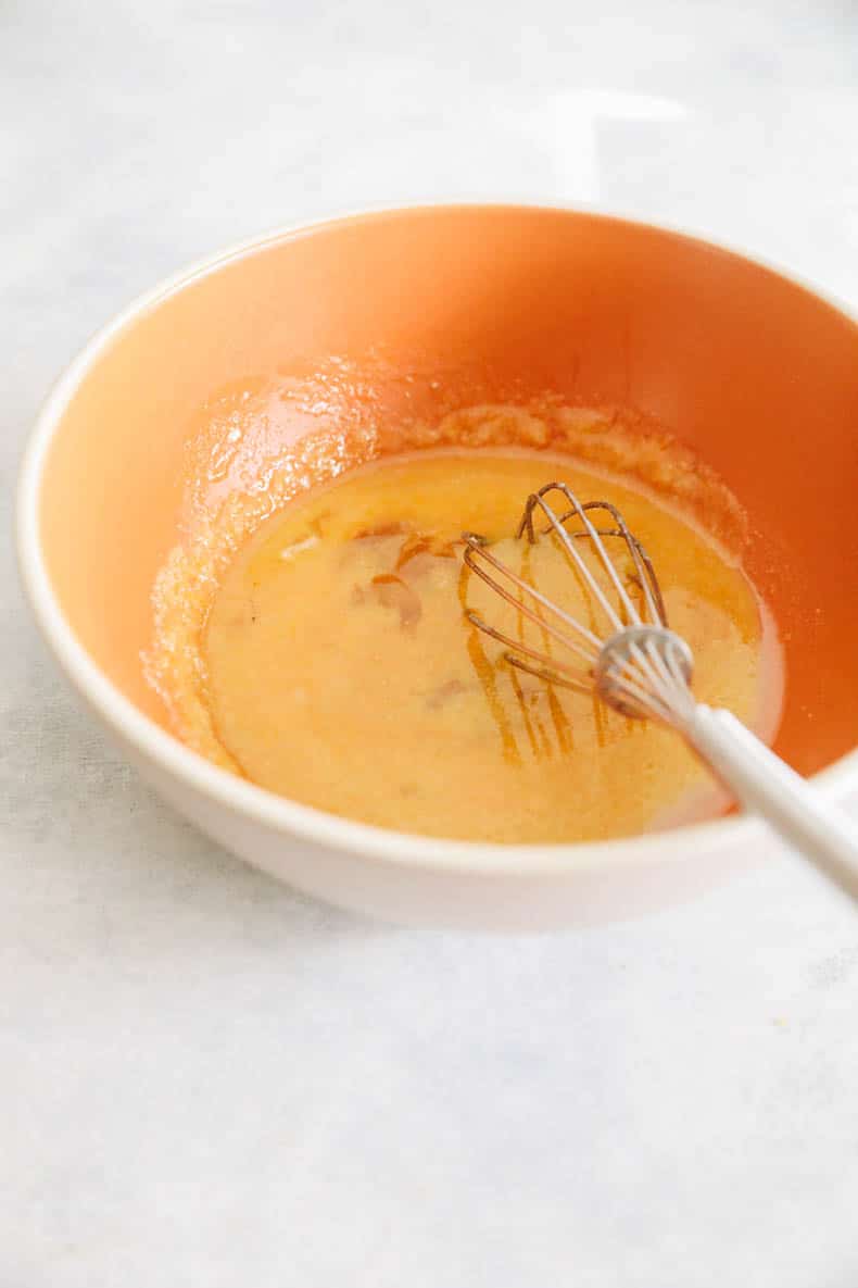 wet batter for protein brownies in an orange bowl.