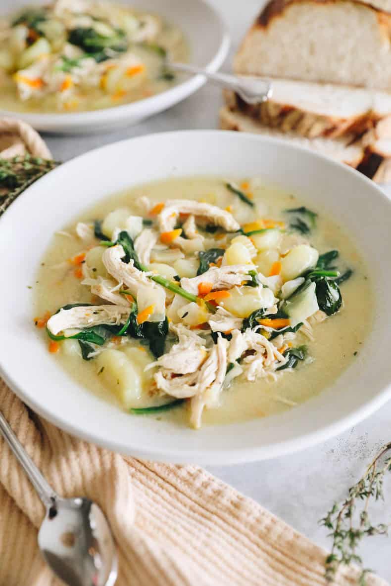 chicken gnocchi soup in a white shallow bowl.