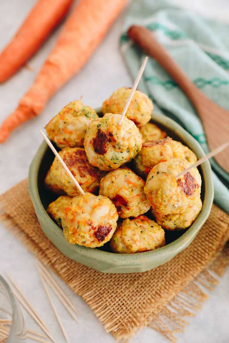 Baked chicken meatballs in a green bowl.