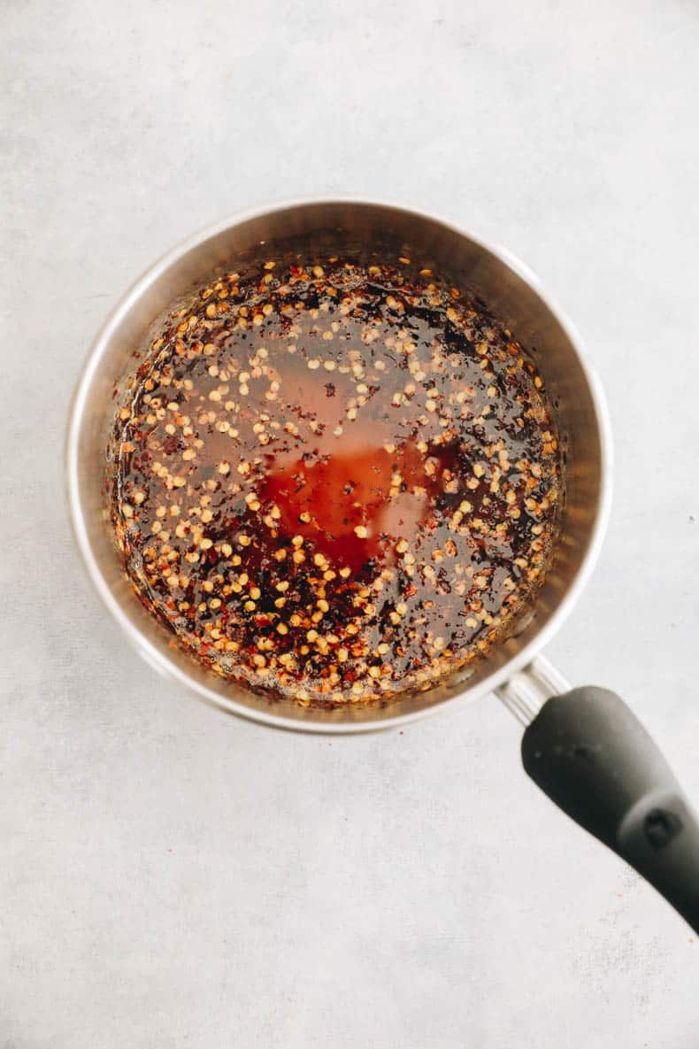 Honey and red chili flakes in a saucepan