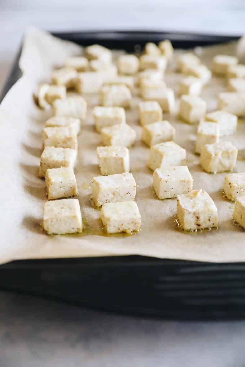 baked tofu on a parchment-lined sheet pan