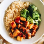 honey garlic tofu over a bed of rice with roasted broccoli