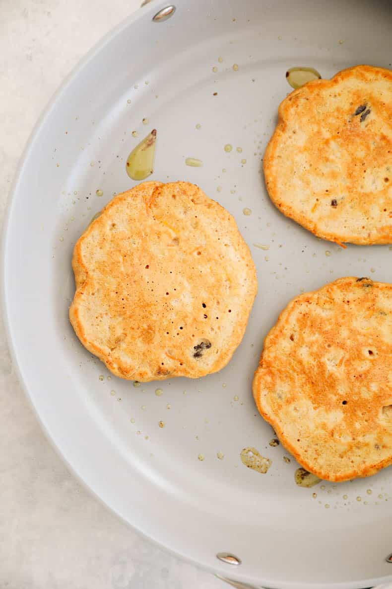 carrot cake pancakes in a skillet.