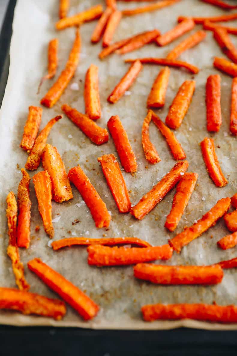 crispy baked carrot fries on a baking sheet