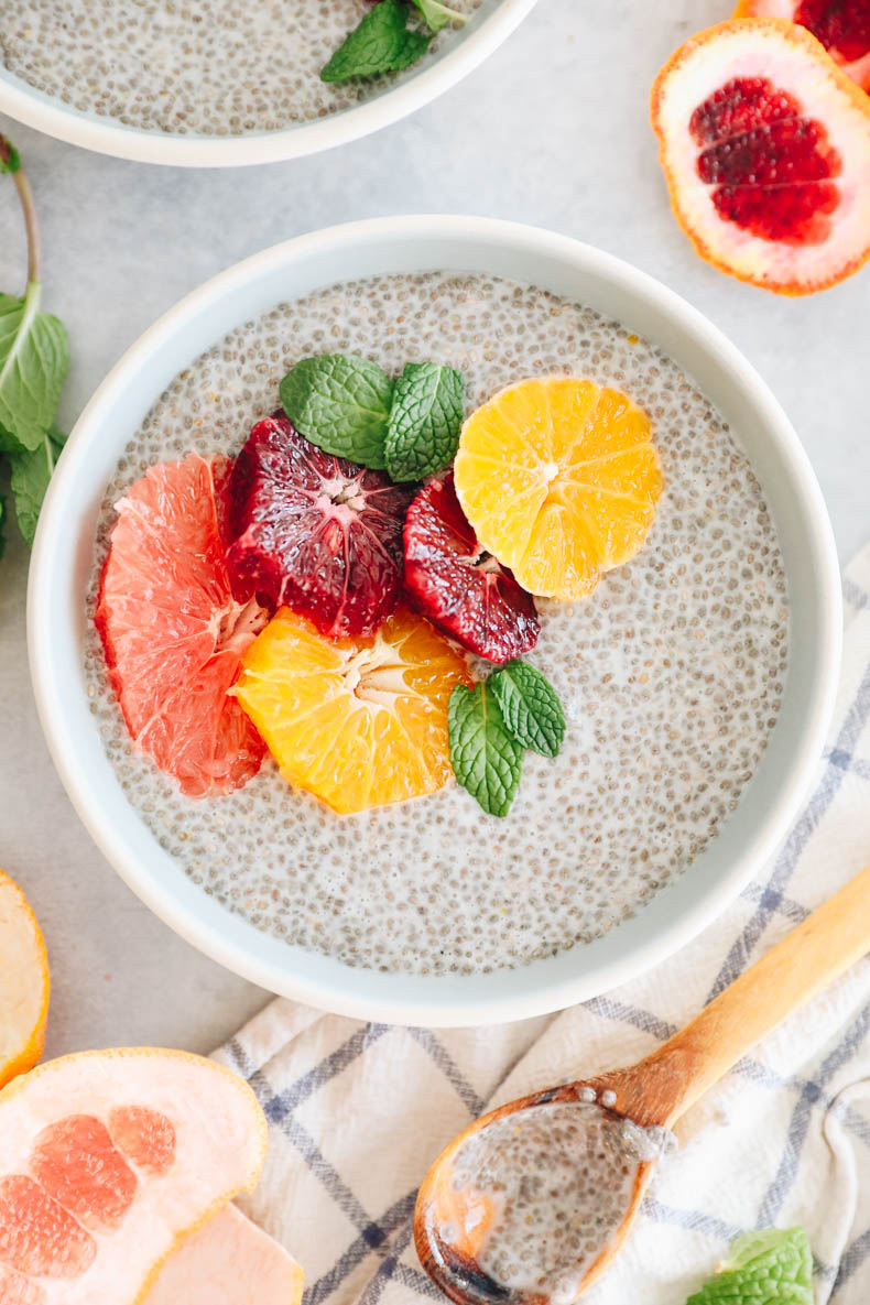 close up image of chia pudding in a blue and white bowl with grapefruit, blood orange and tangelo.