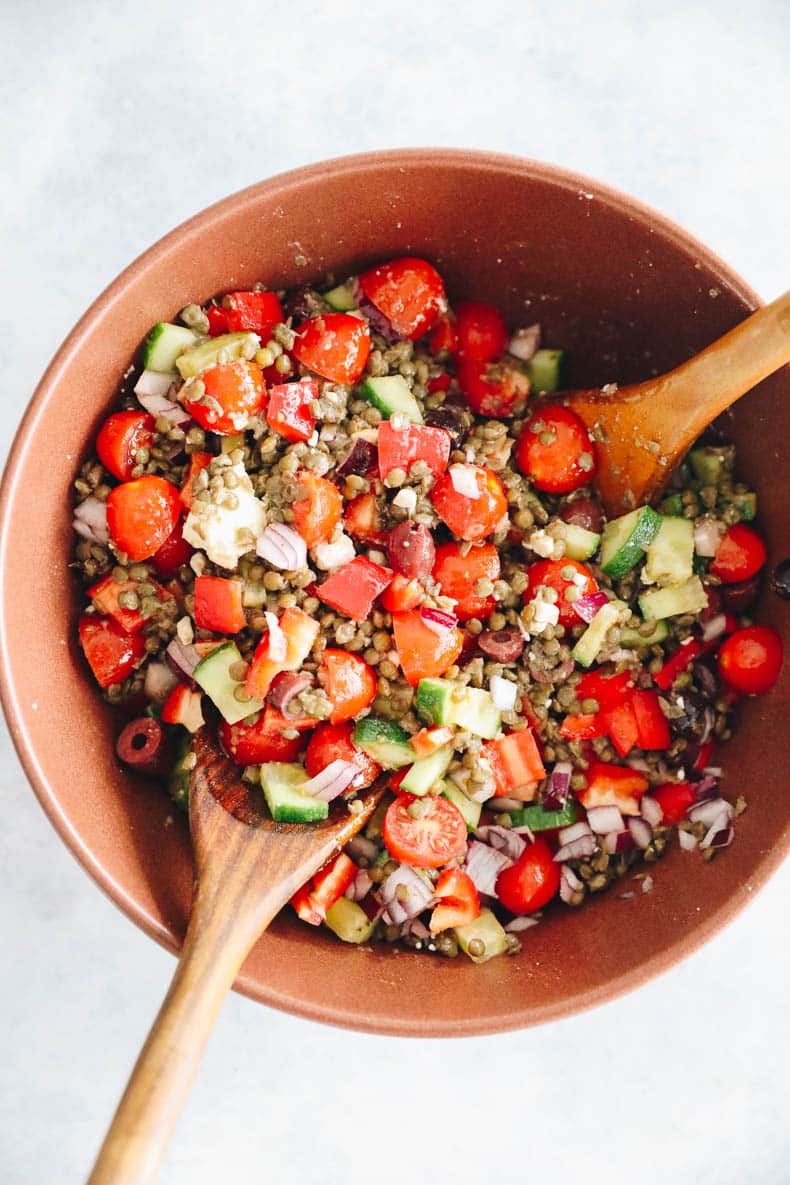 A large brown bowl with lentil salad.